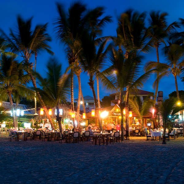 Scene of Cabarete at night, with restaurants and bars along the beach